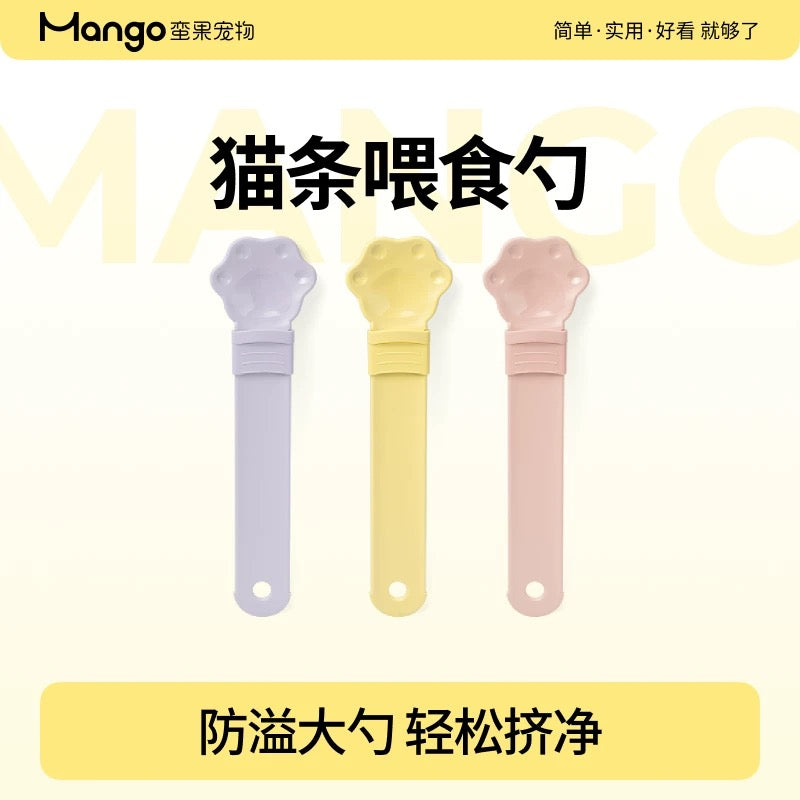 Three colorful pet feeding spoons with Mango branding on a yellow background
